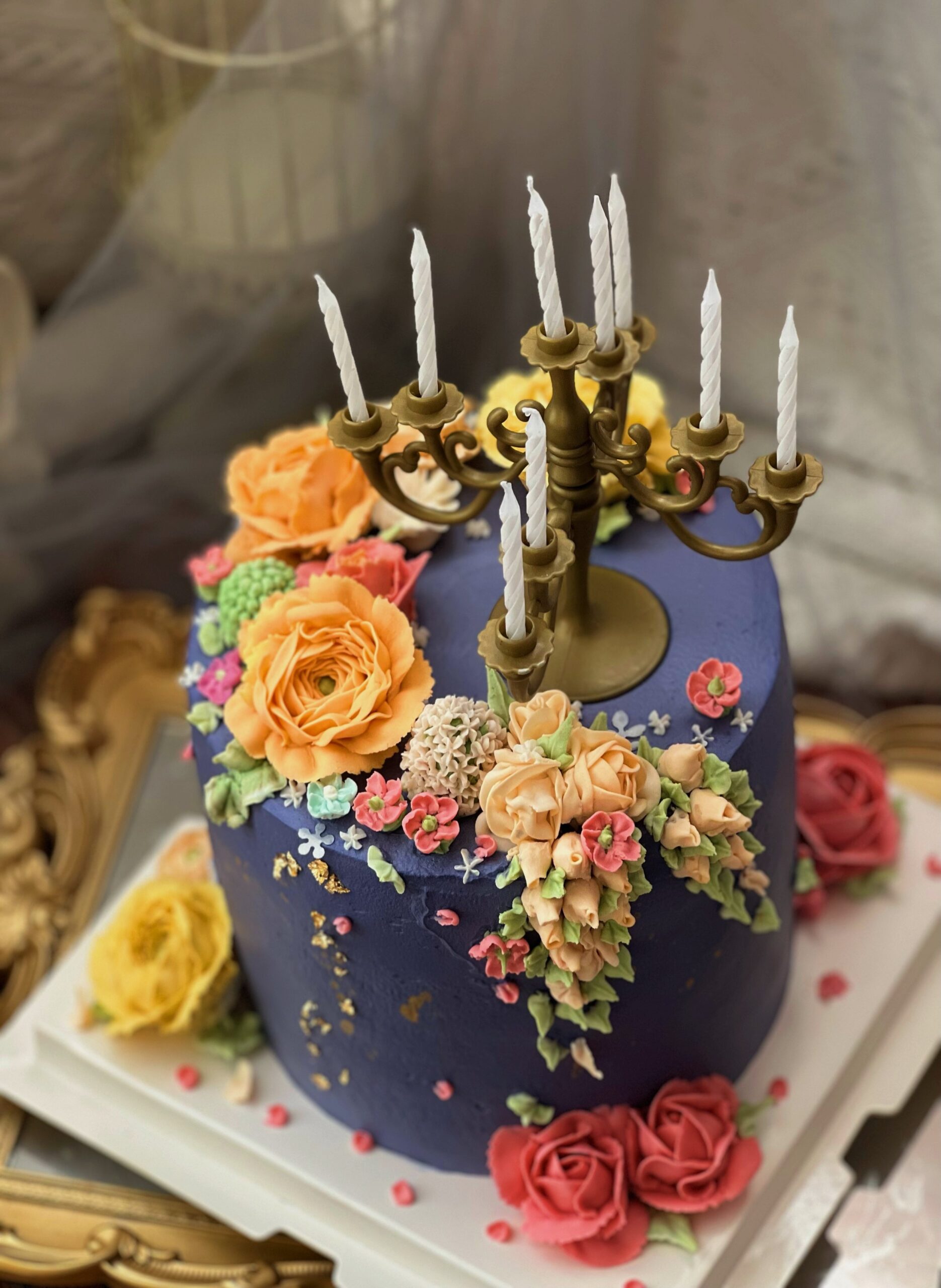 A close-up view of the intricate details on the Candlestick Cake, showcasing the rich blue and purple hues that symbolize tranquility and luxury.